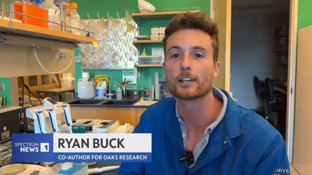 Ryan Buck in a lab speaking about genomics techniques.