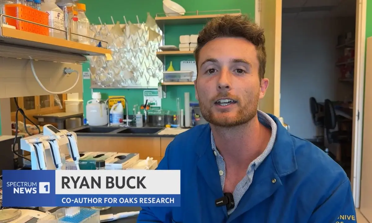 Ryan Buck in a lab speaking about genomics techniques.