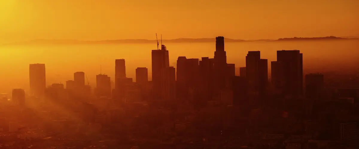 Warm orange sunset behind the skyline of Los Angeles.