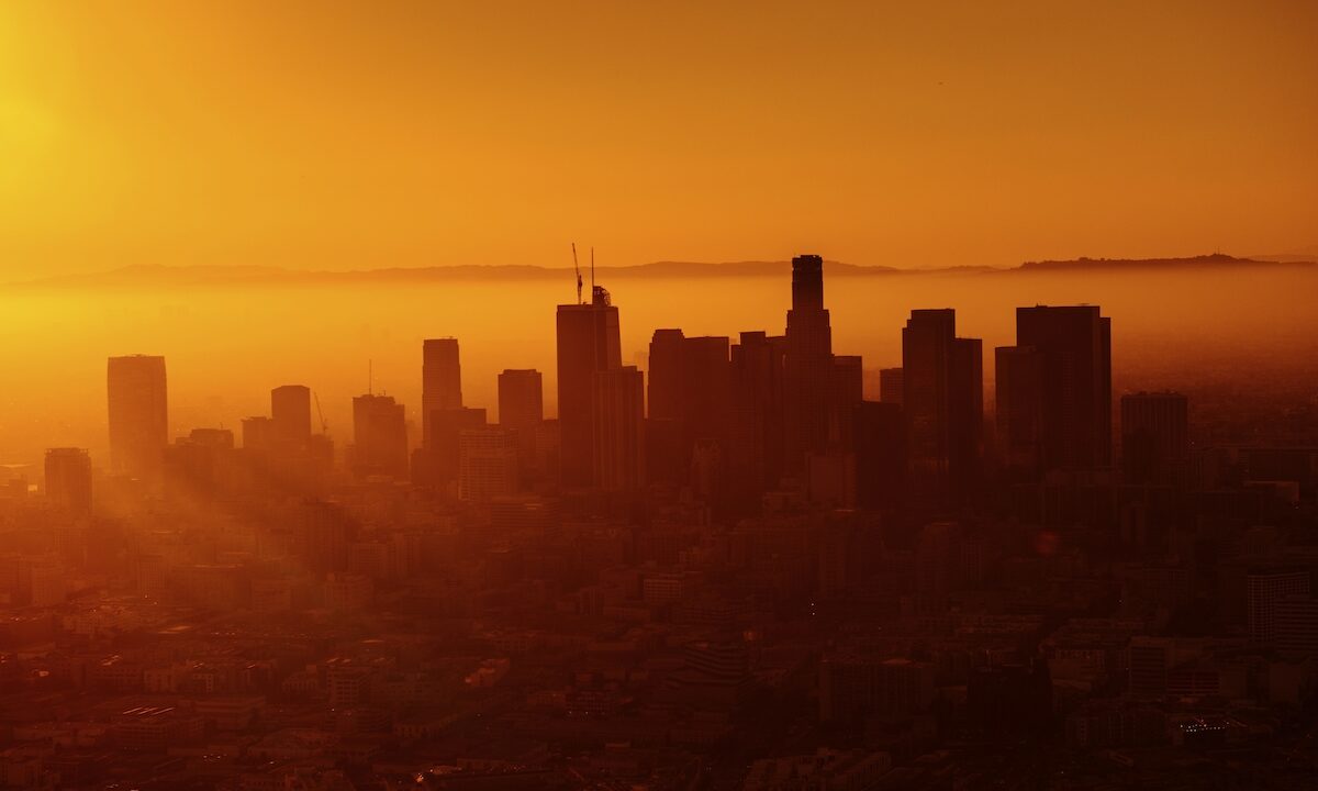 Warm orange sunset behind the skyline of Los Angeles.