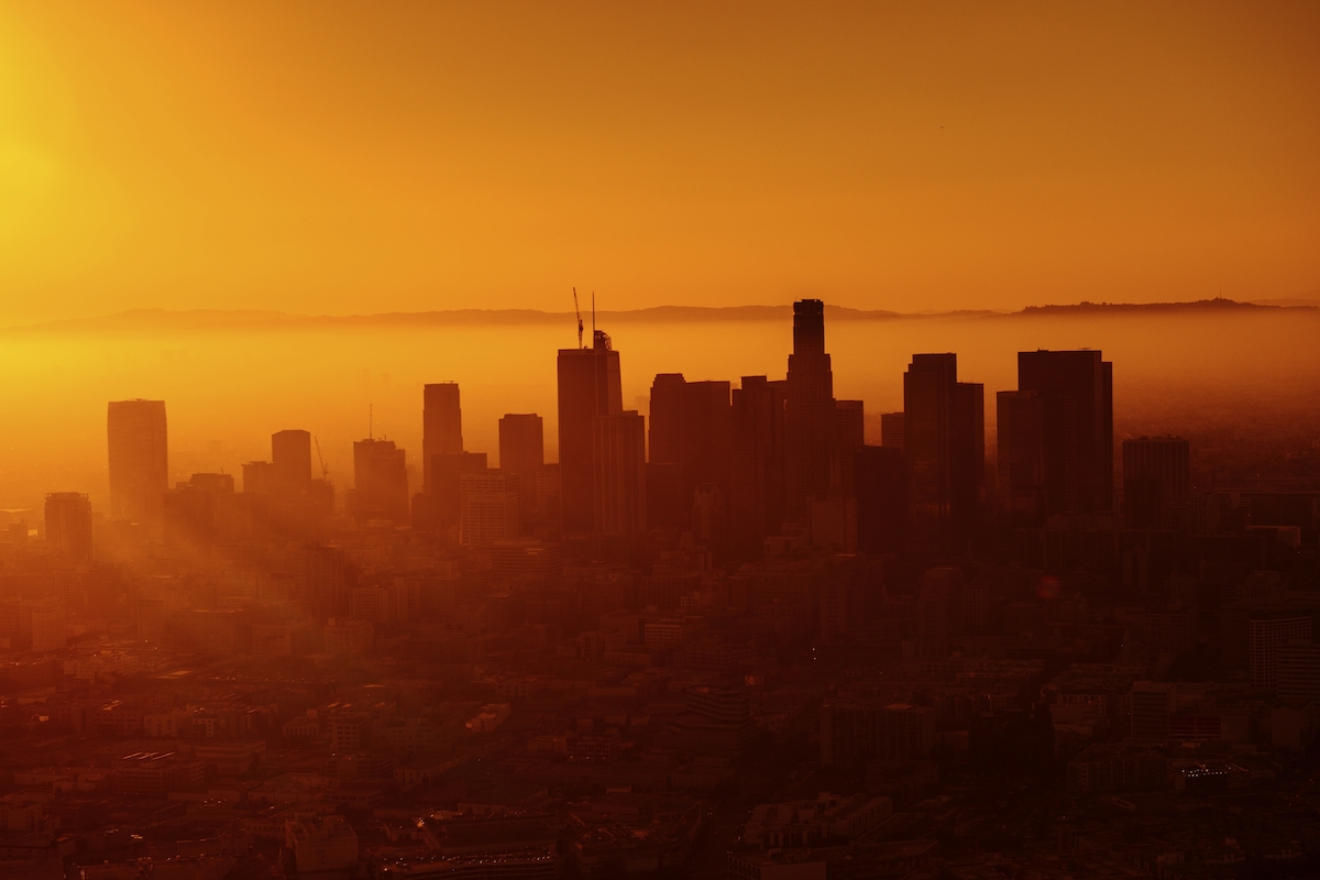 Warm orange sunset behind the skyline of Los Angeles.