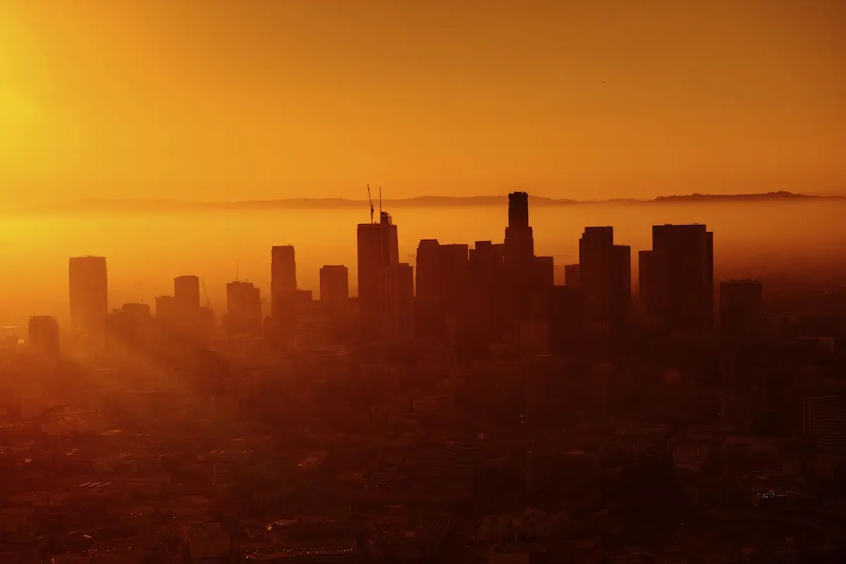 Warm orange sunset behind the skyline of Los Angeles.
