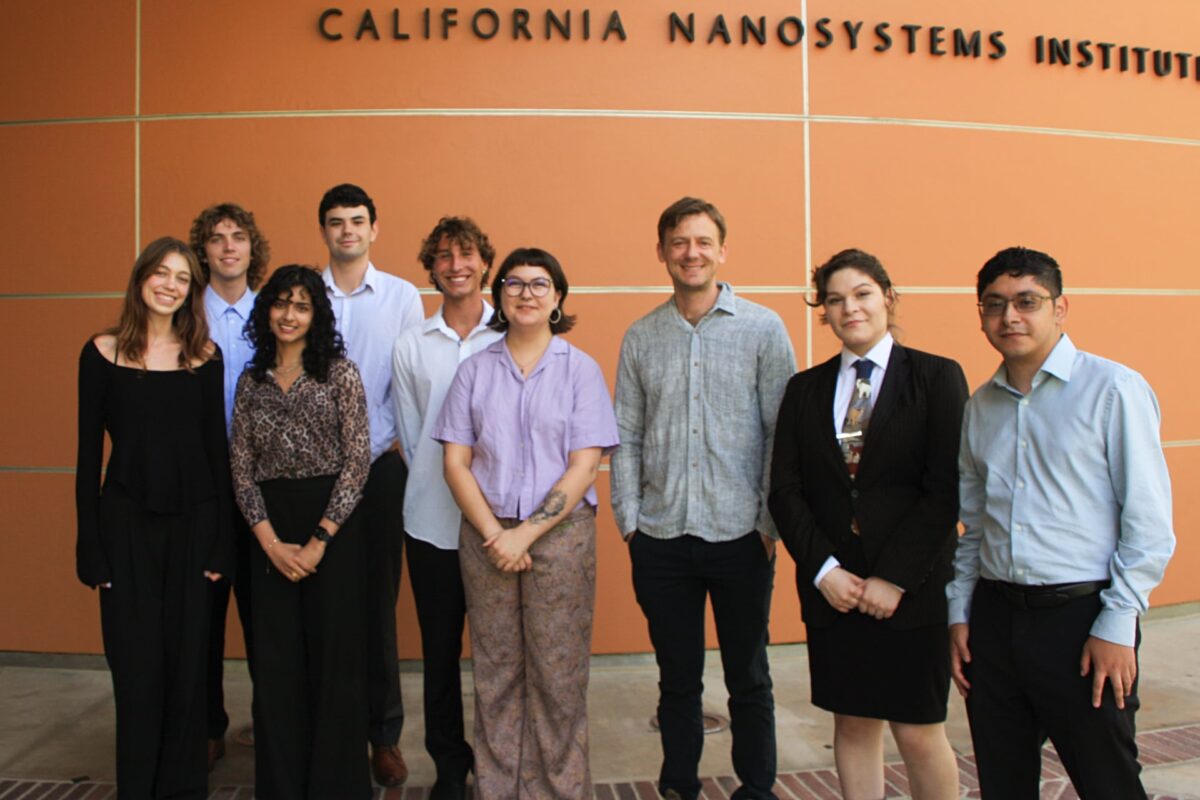 A practicum team stands together outside the California NanoSystems Institute building at UCLA.