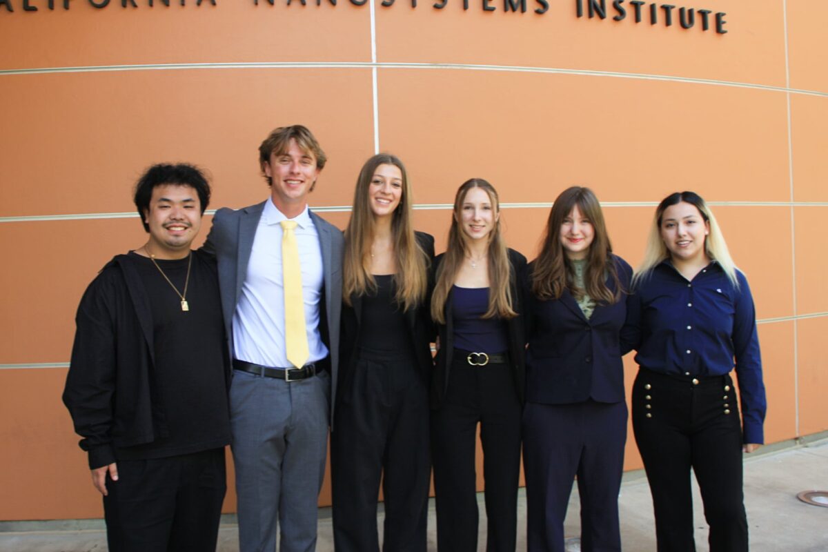 A practicum team stands together outside the California NanoSystems Institute building at UCLA.