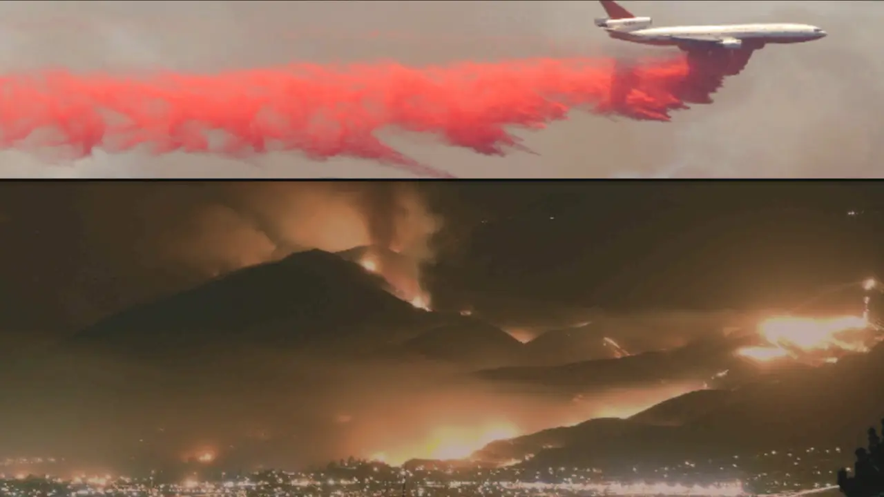 A plane dumping orange fire suppressant above a landscape burning.