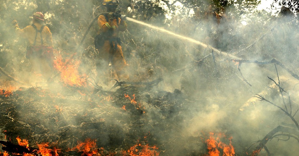 ‘repugnant and dangerous’: ignoring role of climate crisis, trump offers buffoonery on california wildfires
